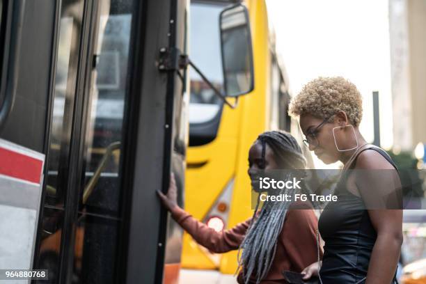 Two Businesswoman Getting On The Bus Brazil Stock Photo - Download Image Now - Bus, Brazil, Rio de Janeiro