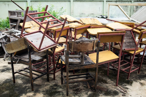 istock Abandoned broken vintage wooden lecture chairs in old school 964883284