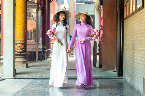 Beautiful women with Vietnam culture traditional dress, Ao dai is famous traditional costume , Ho Chi minh Vietnam.