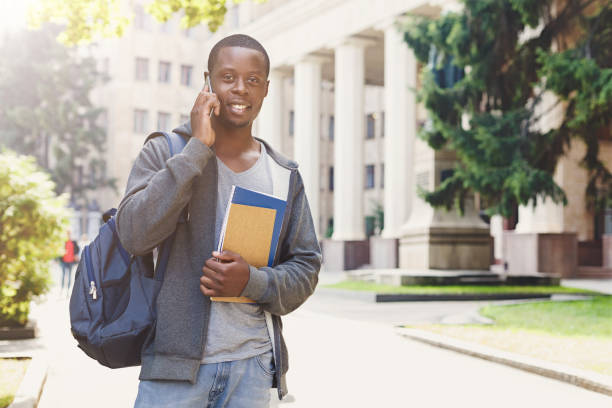 istock Young student talking on smartphone in the park 964887594