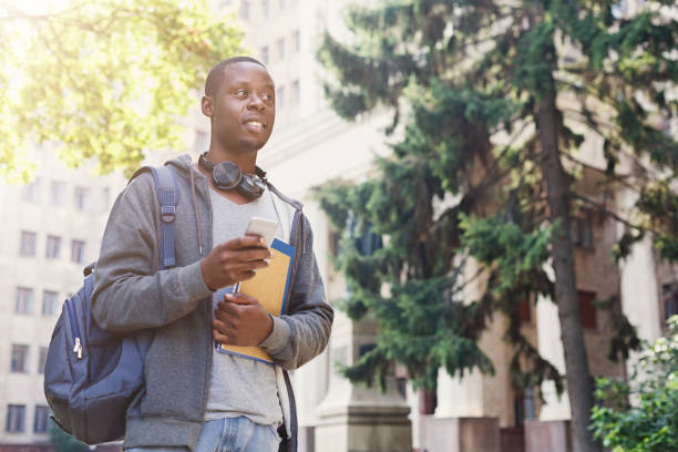 istock African-american student with books at university 964887640