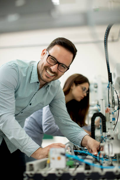 istock Young couple of students at robotics lab 964887858