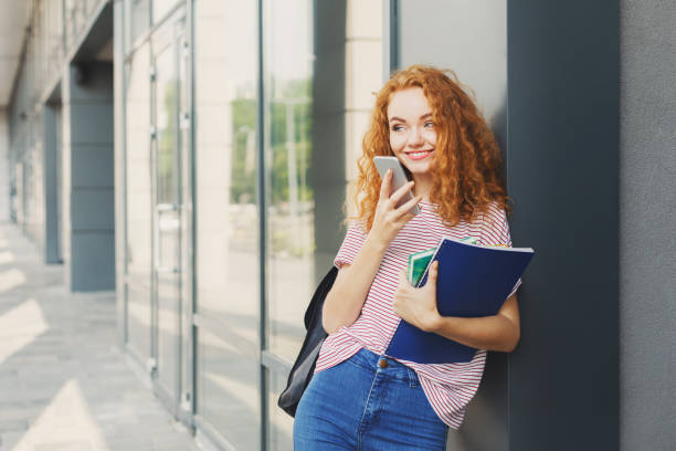 istock Student girl with books on university background 964888374