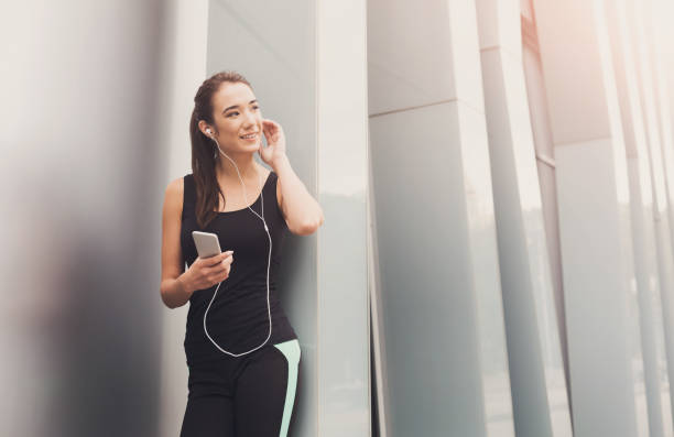 istock Cheerful sporty woman having rest after workout 964891214