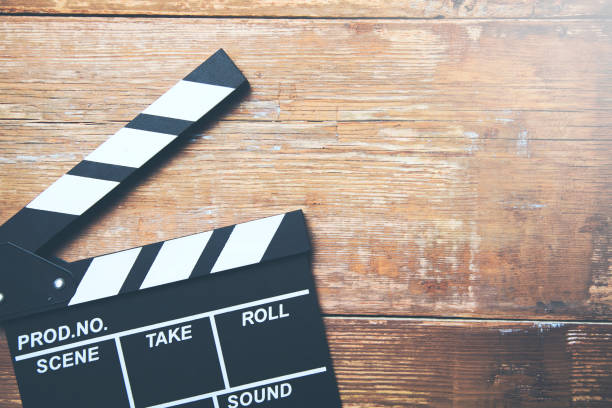 istock Movie clapper on wooden planks background 964895586