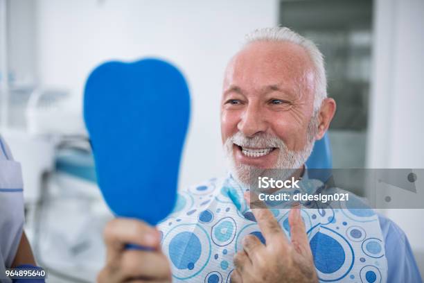 Smiling And Satisfied Patient After Treatment Stock Photo - Download Image Now - Dentist, Senior Adult, Smiling