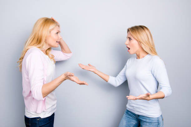 istock Misunderstanding disagreement insult concept, nervous irritated unhappy disappointed upset mother and daughter yelling at each other arguing having dispute quarrel isolated on grey background 964895794