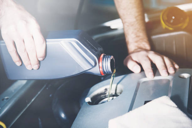 istock Man checking  oil of an older car 964895812