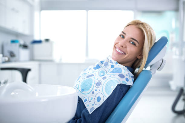 istock Smiling and satisfied patient in a dental office 964898424