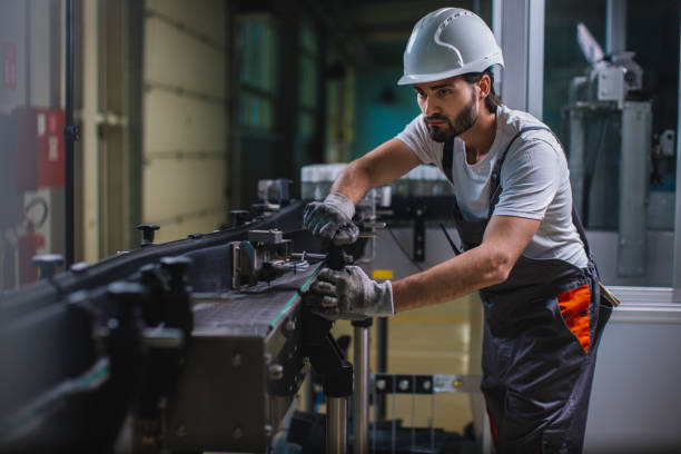 istock Factory worker controlling  machine at the manufacture 964899852