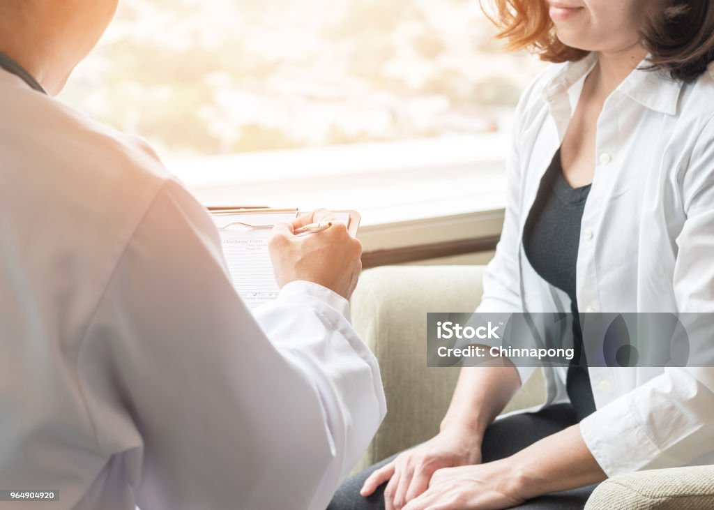 Doctor (obstetrician, gynecologist or psychiatrist) consulting and diagnostic examining female patient's on womanâs obstetric - gynecological health in medical clinic or hospital healthcare service center Doctor Stock Photo