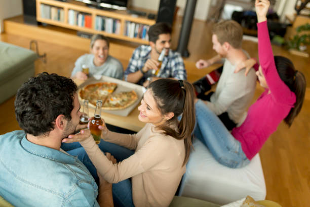 istock Young people having pizza party in the room 964905062