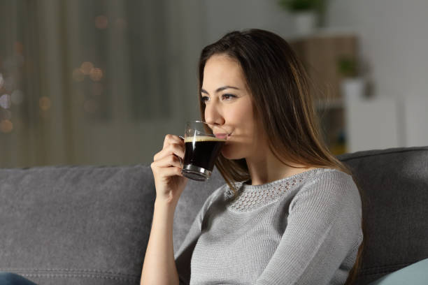 istock Relaxed woman drinking decaffeinated coffee in the night 964911936
