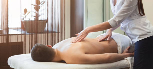 istock Woman massaging male shoulders and back 964912464