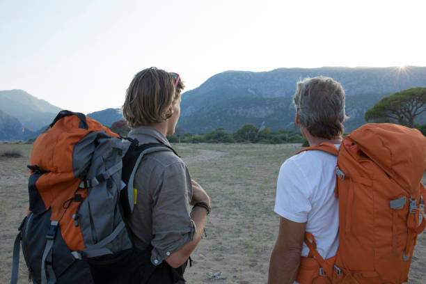istock Father and son hiking in mountains, with backpacks 964915162