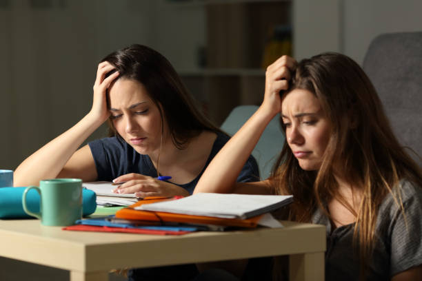 istock Frustrated students studying late hours in the night 964915164