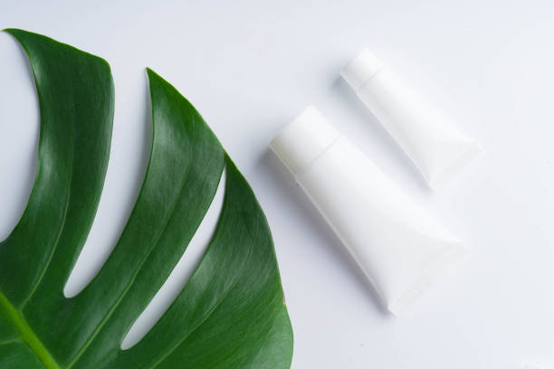 istock Beautiful natural cosmetics and leaves on light background 964915172
