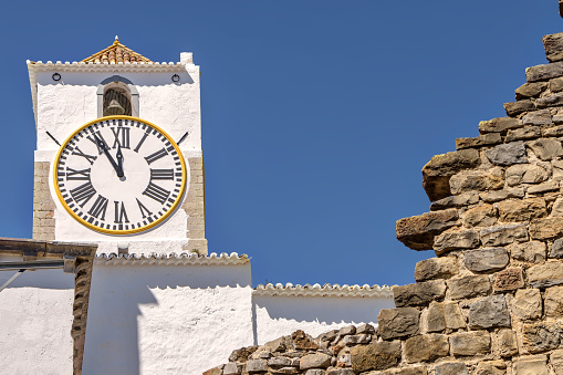 View of famous clock tower in Tavira, Portugal.