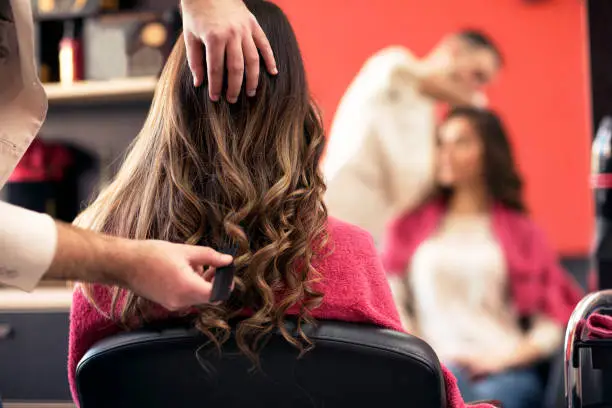 Photo of Woman getting her hair done in the salon