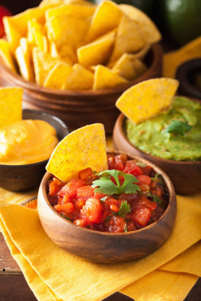 istock mexican nachos tortilla chips with guacamole, salsa and cheese dip 964924448