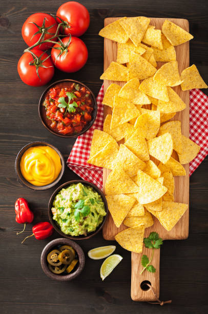 istock mexican nachos tortilla chips with guacamole, salsa and cheese dip 964924986