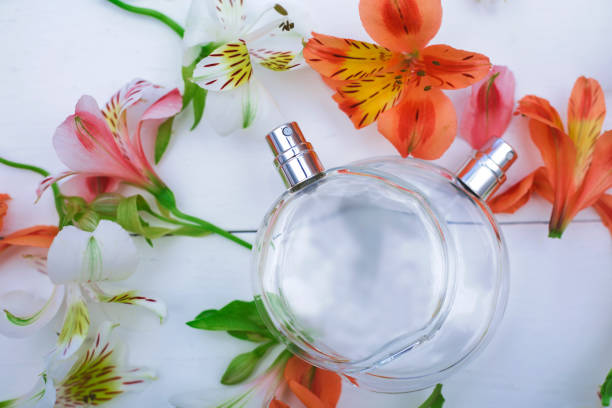istock Two bottle of perfumes with flowers on white background 964926234