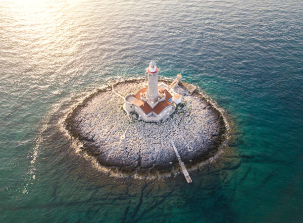 istock Little island with lighthouse 964929024