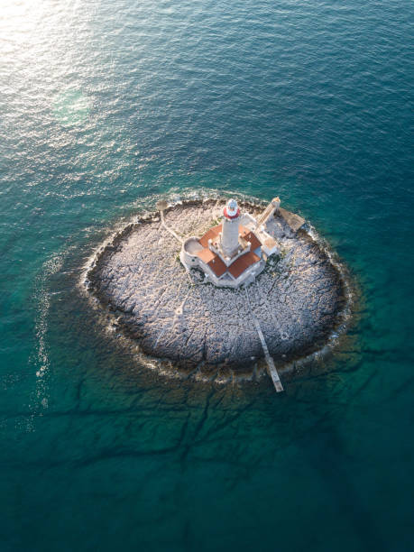 istock Little island with lighthouse 964929028