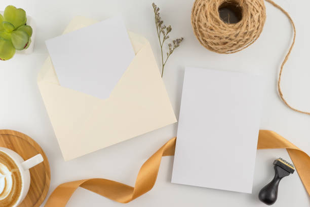 istock A wedding concept. Wedding Invitation, envelopes, cards Papers on white background with ribbon and decoration. Top view, flat lay, copy space 964929076