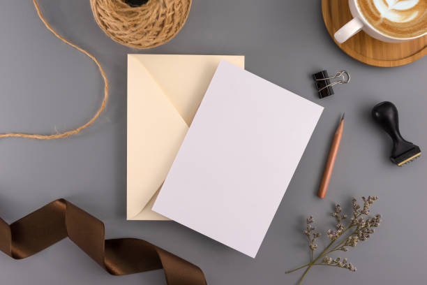 istock A wedding concept. Wedding Invitation, envelopes, cards Papers on grey background with ribbon and decoration. Top view, flat lay, copy space 964929206