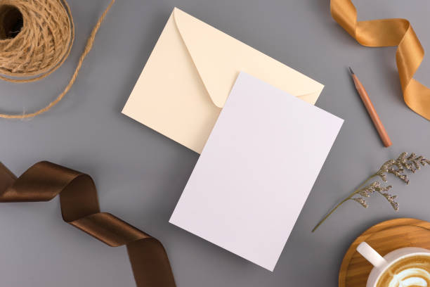 istock A wedding mock up concept. Wedding Invitation, envelopes, cards Papers on grey background with ribbon and decoration. Top view, flat lay, copy space 964929234