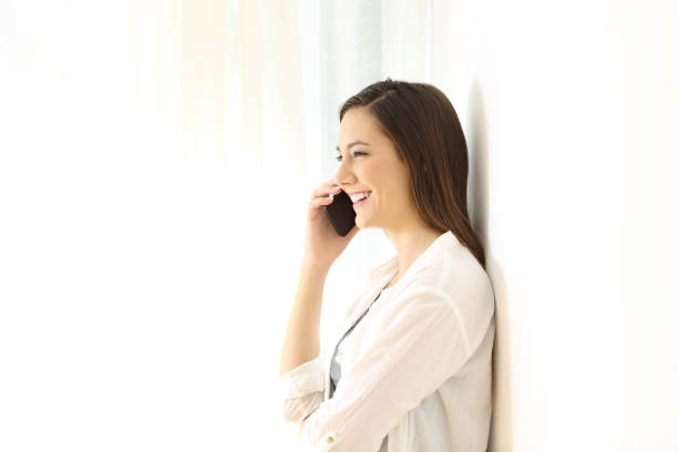 istock Profile of a woman calling on phone isolated on white at side 964929530