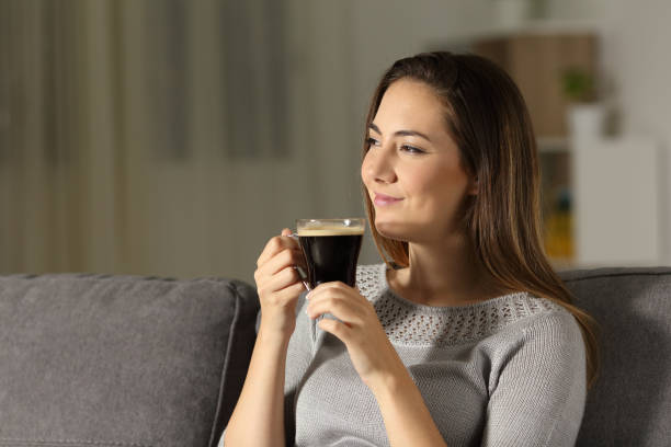 istock Satisfied woman enjoying coffee in the night 964929662