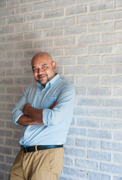 istock Muslim adult leaning against brick wall 964930054