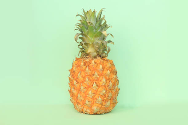 istock juicy pineapple on a light green background 964930326