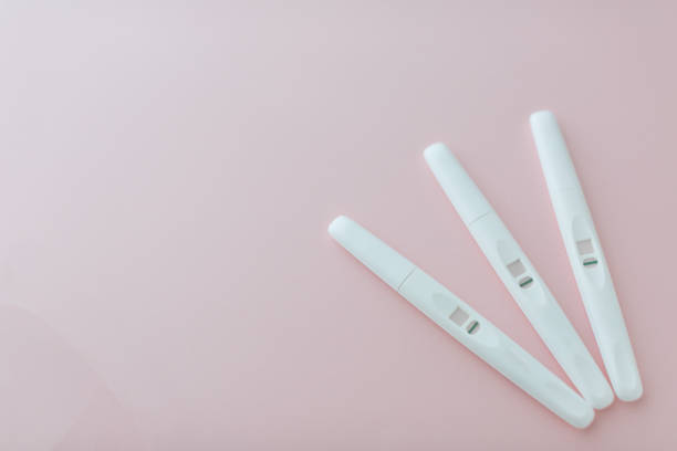 Three negative pregnancy tests on the pink background Three white negative pregnancy tests on the light pink background. Copy space infertility stock pictures, royalty-free photos & images