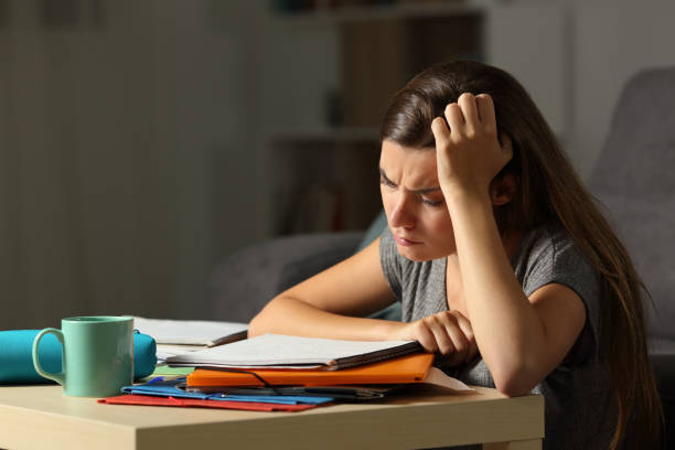 istock Tired student studying late hours in the night 964933936