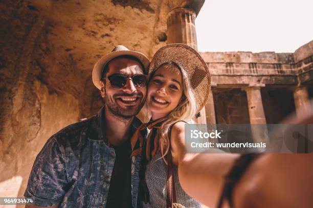 Young Tourists Couple Taking Selfies At Ancient Monument In Italy Stock Photo - Download Image Now