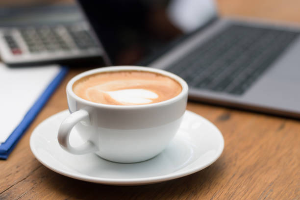 istock late art hot coffee on wooden floor 964938116