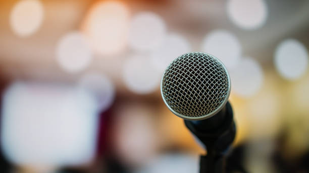 istock Seminar Conference Concept : Microphones for speech or speaking  in seminar room, talking for lecture to audience university, Event light convention hall Background. 964938260