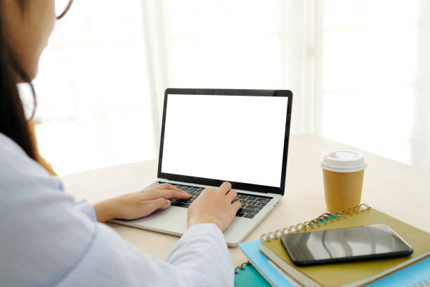 istock Young asian woman using laptop computer with blank screen for mock up template background, technology and lifestyle, working at home background concept 964941350