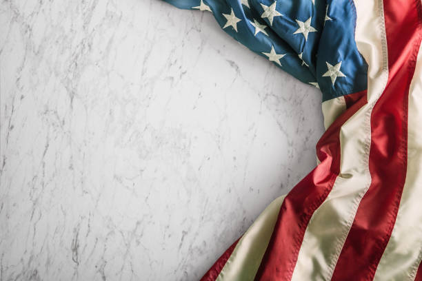 istock Close-up american flag on white marble background 964941516