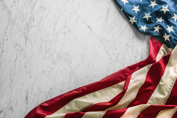 istock Close-up american flag on white marble background 964941526