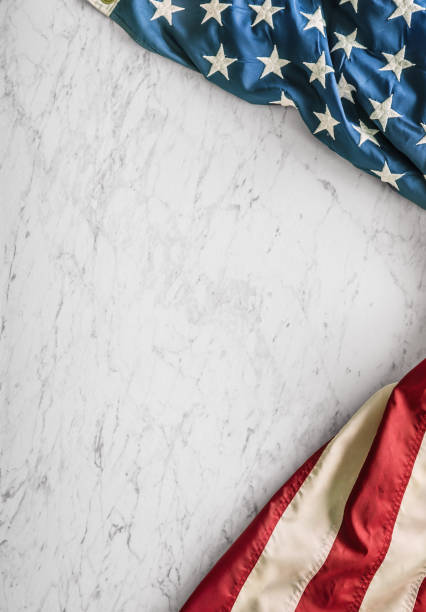 istock Close-up american flag on white marble background 964941528
