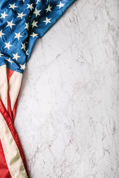 istock Close-up american flag on white marble background 964941540
