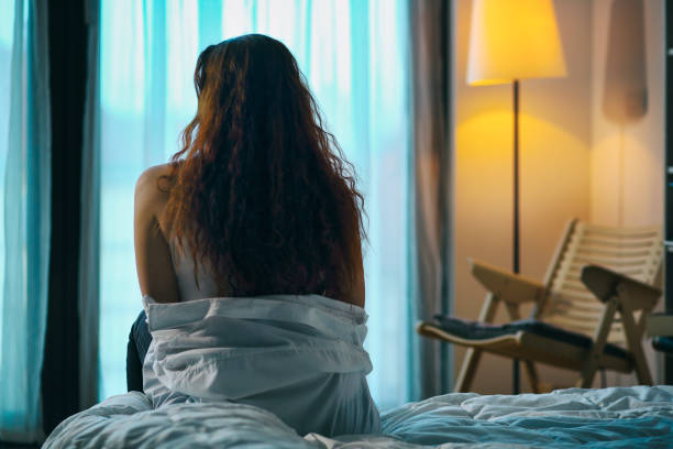 istock Woman sitting on the bed 964941586