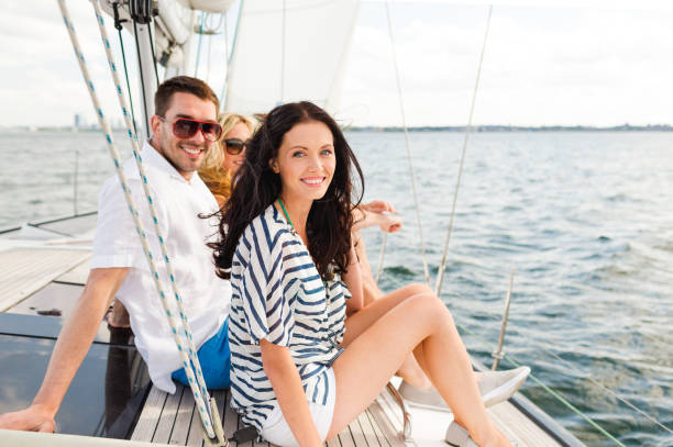 istock smiling friends sitting on yacht deck 964945166