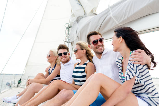 istock smiling friends sitting on yacht deck 964948760