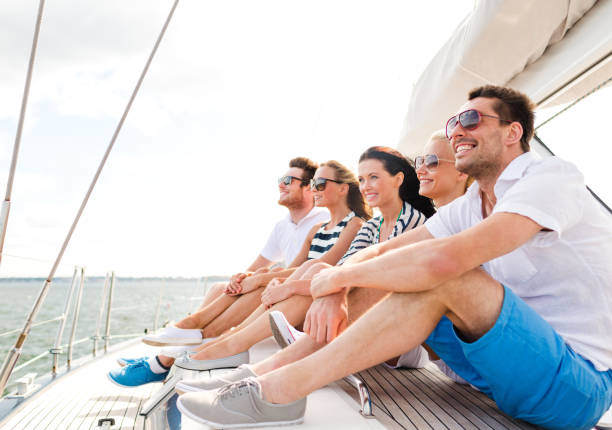 istock smiling friends sitting on yacht deck 964948936