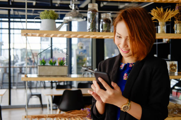 istock Businesswoman using smartphone in modern office. 964956202